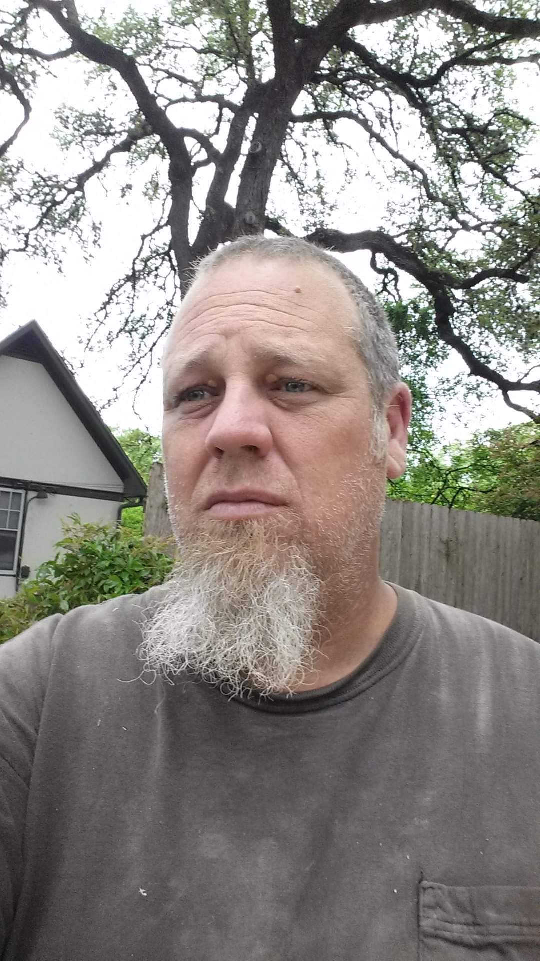 Clayton Loban standing beneath oak tree.