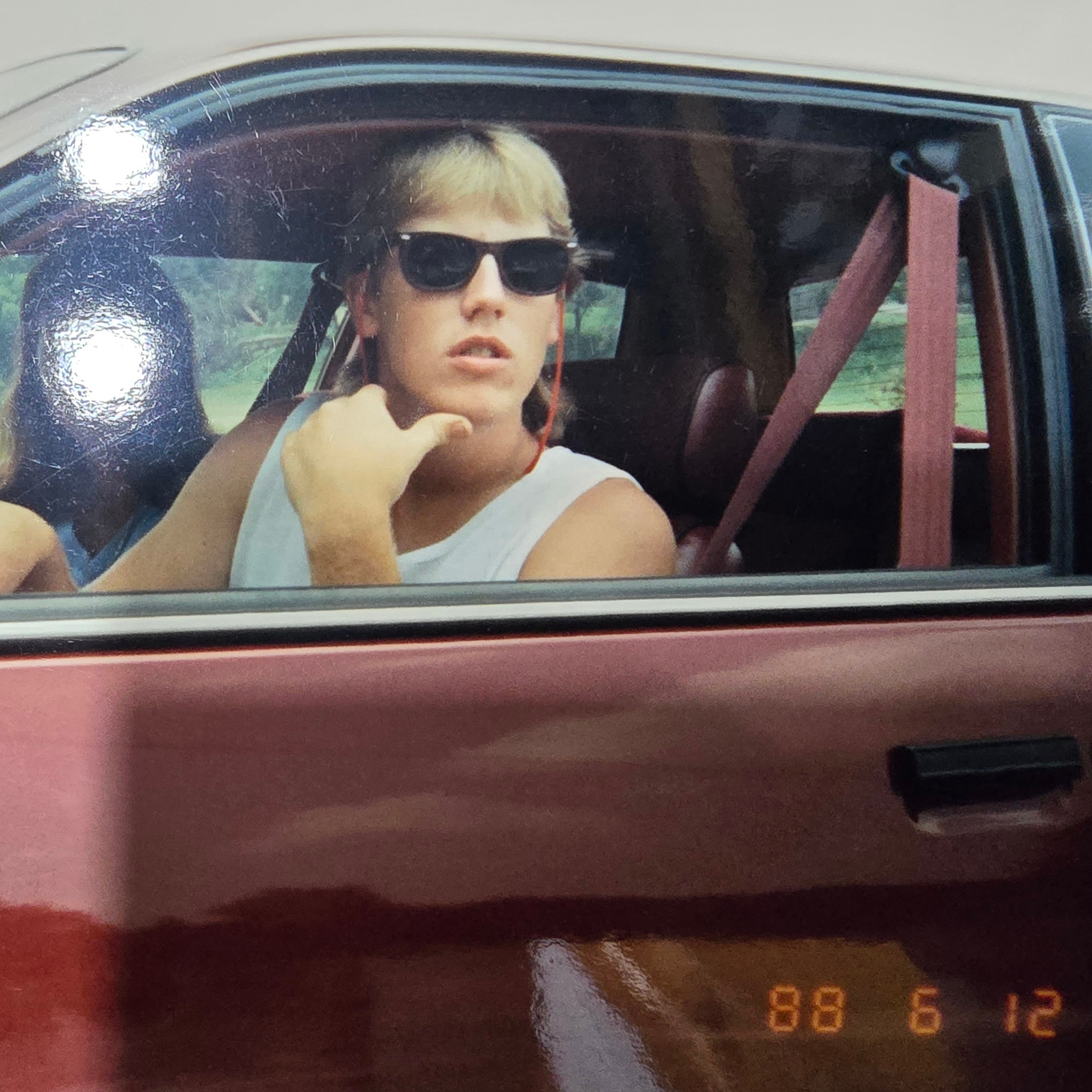 Young adult picture of Clayton Loban seated inside vehicle.