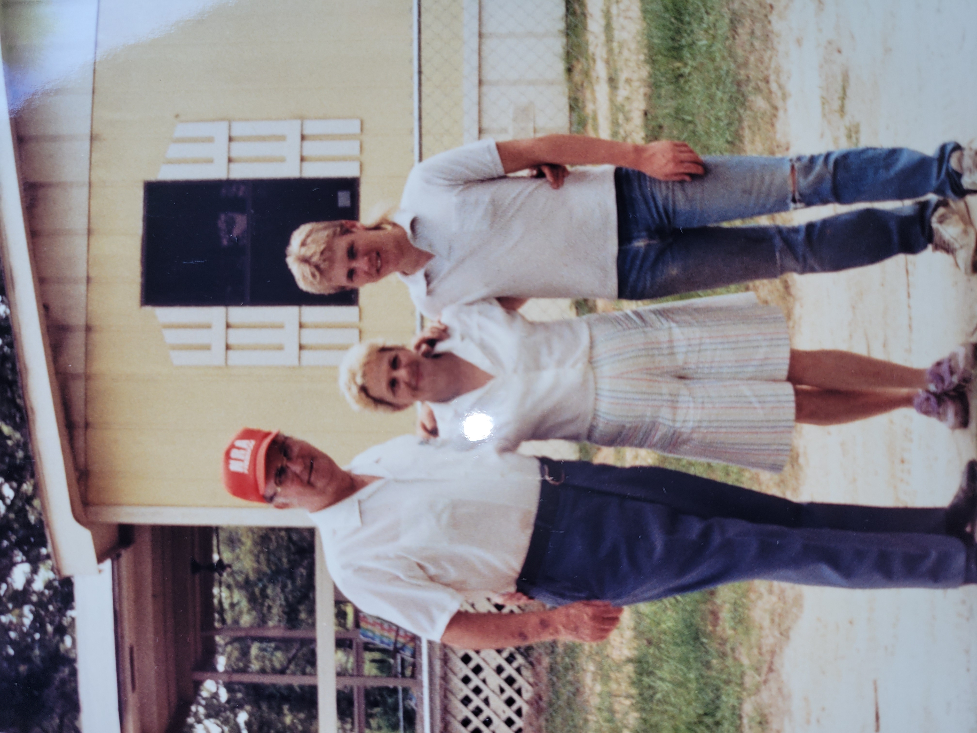 Clayton Loban with maternal grandparents outside family home.