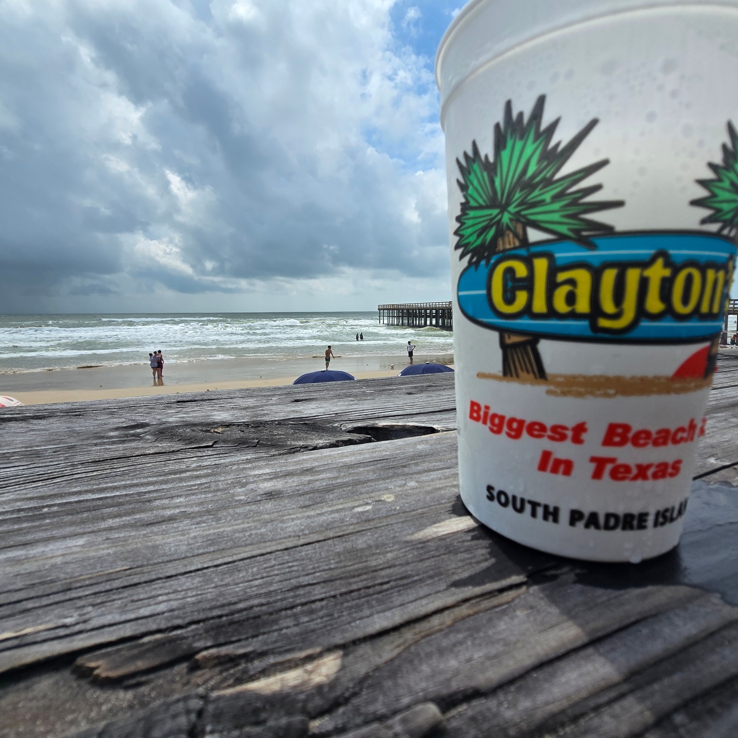 Close-up of drink cup at beach in warm light.