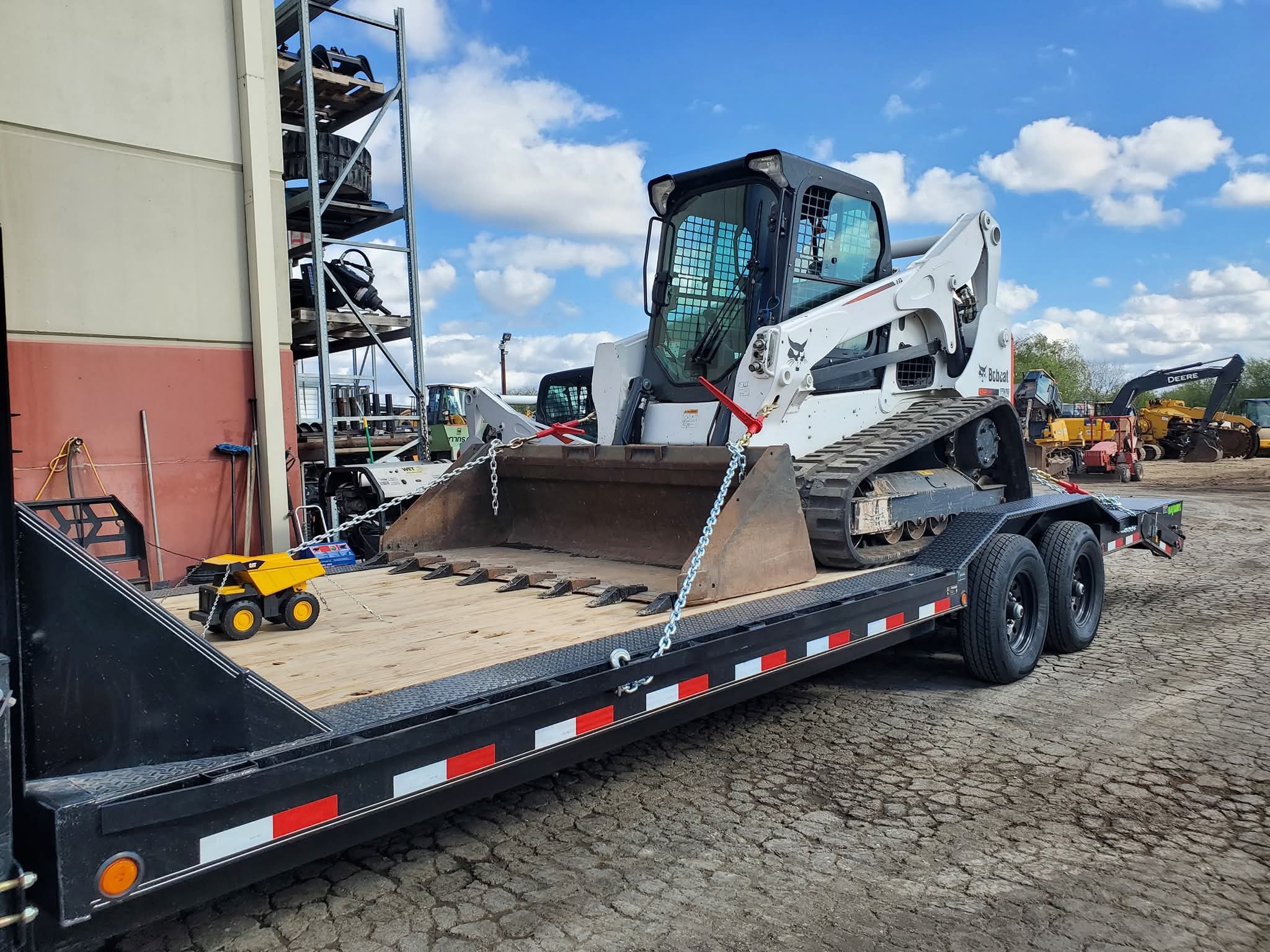 Bobcat skid steer on trailer.